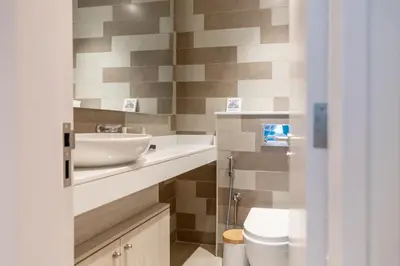 a bathroom with a sink and a toilet at SEVEN PALM by Design Studio 1BR in Dubai