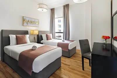 a hotel room with two beds and a television at Stunning 3 plus 1 BR Apartment on JBR Beach with Marina View Near Mall, Metro & Cinemas - By Sunkissed Holiday Homes in Dubai