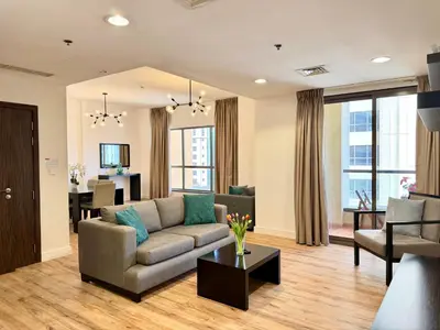 a living room with a couch and a table at Stunning 3 plus 1 BR Apartment on JBR Beach with Marina View Near Mall, Metro & Cinemas - By Sunkissed Holiday Homes in Dubai