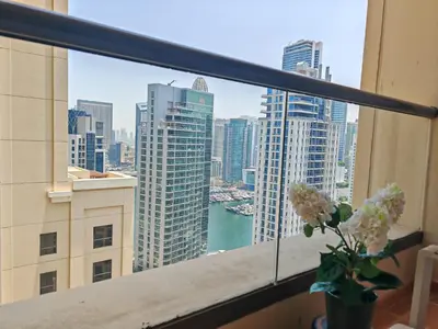 a view of a city skyline from a window at Stunning 3 plus 1 BR Apartment on JBR Beach with Marina View Near Mall, Metro & Cinemas - By Sunkissed Holiday Homes in Dubai