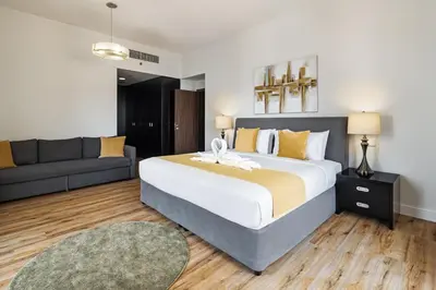 a bedroom with a large bed and a couch at Stunning 3 plus 1 BR Apartment on JBR Beach with Marina View Near Mall, Metro & Cinemas - By Sunkissed Holiday Homes in Dubai