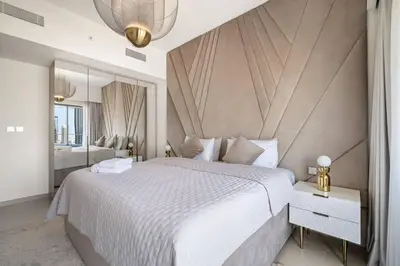 a bedroom with a large white bed and a mirror at **Panoramic Views Of Burj Khalifa and Fountain** in Dubai