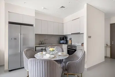 a kitchen with a table and chairs in a kitchen at **Panoramic Views Of Burj Khalifa and Fountain** in Dubai