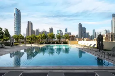 a large swimming pool with a city skyline in the background at **Panoramic Views Of Burj Khalifa and Fountain** in Dubai