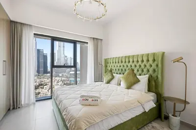 a bedroom with a large bed with a large window at **Panoramic Views Of Burj Khalifa and Fountain** in Dubai