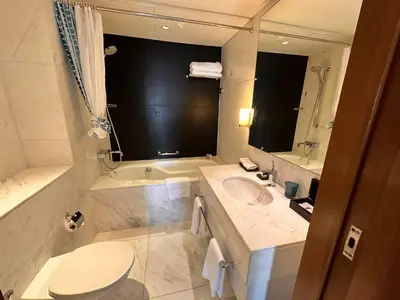 a bathroom with a sink and a toilet and a tub at Suitestay-Formerly Address Dubai Mall Residence-Downtown in Dubai