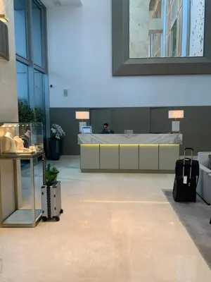 a room with a bed and a person sitting in it at Emaar Residence Fashion Avenue - formerly Address Dubai Mall in Dubai