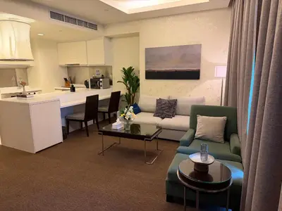 a living room with a couch and a kitchen at Emaar Residence Fashion Avenue - formerly Address Dubai Mall in Dubai