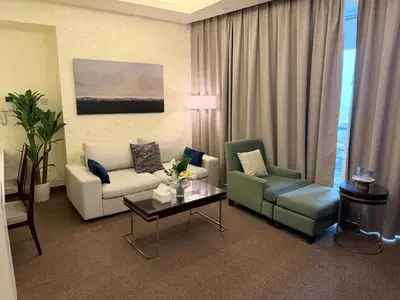 a living room with a couch and chairs and a table at Emaar Residence Fashion Avenue - formerly Address Dubai Mall in Dubai