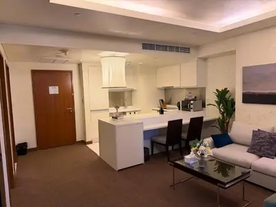 a living room with a couch and a kitchen at Emaar Residence Fashion Avenue - formerly Address Dubai Mall in Dubai