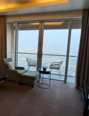 a living room with a couch and a table at Emaar Residence Fashion Avenue - formerly Address Dubai Mall in Dubai
