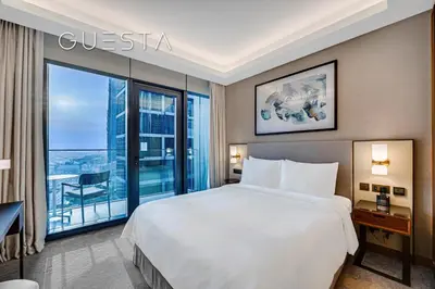 a hotel room with a bed and a large window at Address Residences Dubai Opera, Downtown Dubai in Dubai