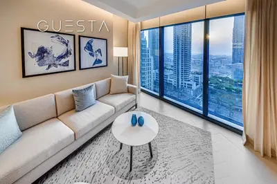a living room with a couch and a table at Address Residences Dubai Opera, Downtown Dubai in Dubai