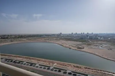 an aerial view of a river and a city at Budget Friendly Production City in Dubai