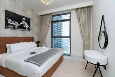 a bedroom with a large bed and a window at Elegant 1BHK Beach Front Perfect Getaway in Dubai