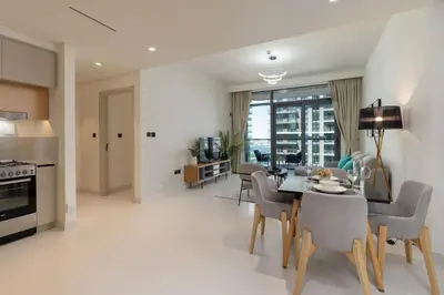 a kitchen and dining room with a table and chairs at Elegant 1BHK Beach Front Perfect Getaway in Dubai