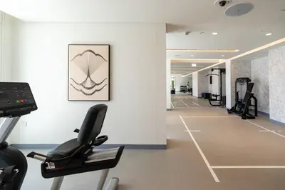 a fitness room with a treadmill and a gym at Elegant 1BHK Beach Front Perfect Getaway in Dubai