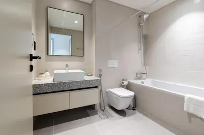 a bathroom with a sink and a tub and a toilet at Elegant 1BHK Beach Front Perfect Getaway in Dubai