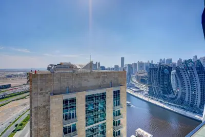a view of a city with a river and buildings at Serene City Stays Binghatti Canal Luxe 2BR in Dubai