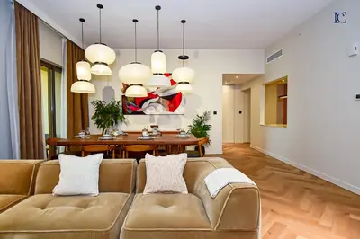 a living room with a couch and a table at Luxury Escapes - Charming 3BR plus maids Apt near JBR Beach - Sadaf 1 in Dubai