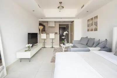 a large white living room with a blue couch at Frank Porter - Al Waleed Paradise in Dubai