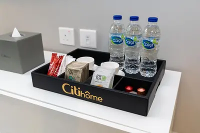 a tray with bottles of water sitting on a counter at CitiHome - Prime Stylish Studio in Sports City in Dubai