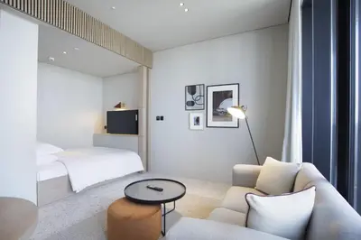a living room with a couch and a bed at Studio with Burj Khalifa View - Upside Living in Dubai