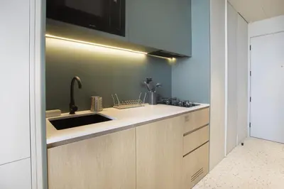 a kitchen with a sink and a microwave at Studio with Burj Khalifa View - Upside Living in Dubai