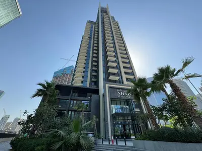 a tall building with palm trees in front of it at Ahad Residences Studio- 15mins walk to Dubai Mall in Dubai