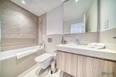 a bathroom with a toilet and a sink and a mirror at Exquisite 1BR at Downtown Views II Tower 2 Downtown Dubai by Deluxe Holiday Homes in Dubai