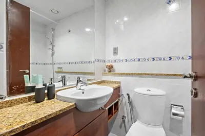 a bathroom with a white toilet and a sink at StoneTree - Cozy Studio - JLT in Dubai