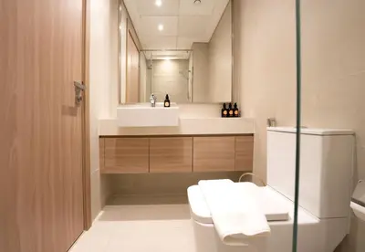a bathroom with a sink and a toilet and a mirror at EasyGo - Azizi Riviera 9 Bright Studio in Dubai