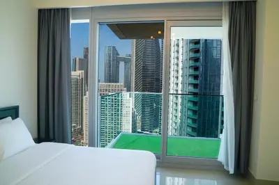a bedroom with a bed and a large window at Magnificent 3BR with Incredible Burj & Fountain View in Dubai