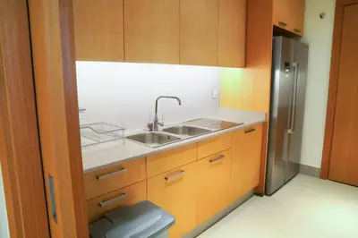 a kitchen with a sink and a refrigerator at Magnificent 3BR with Incredible Burj & Fountain View in Dubai