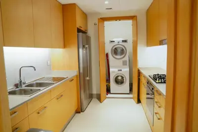 a kitchen with a sink and a washer and dryer at Magnificent 3BR with Incredible Burj & Fountain View in Dubai