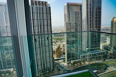 a view of a city from a balcony in a skyscraper at Magnificent 3BR with Incredible Burj & Fountain View in Dubai