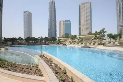 a large swimming pool in a city with tall buildings at Burj Vista Burj Khalifa Metro & Mall Access in Dubai