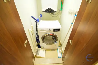 a washing machine in a room with a door at Burj Vista Burj Khalifa Metro & Mall Access in Dubai