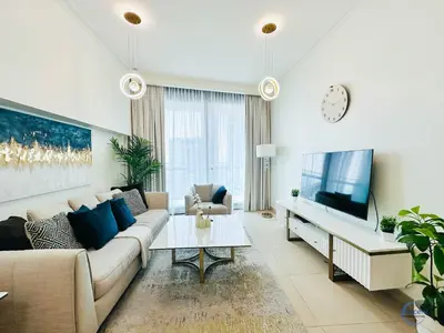 a living room with a couch and a tv at Burj Vista Burj Khalifa Metro & Mall Access in Dubai
