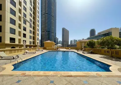 a large swimming pool in a city with tall buildings at Bahar - Luxury 1BR - Near JBR Beach - Prime Location - JBR in Dubai