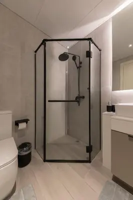 a shower with a glass door in a bathroom at Fresh & Quiet 1BR at Midtown Noor 4 Tower in Dubai