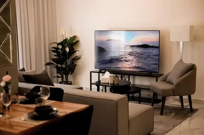 a living room with a couch and a flat screen tv at Dubaistay Luxury 2 Bedroom holiday appartment JVC KING and QUEENSIZE in Dubai
