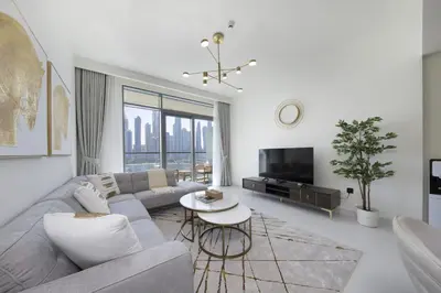 a living room with a couch and a table at 2BR Emaar Beachfront with Full Sea & Skyline Views in Dubai
