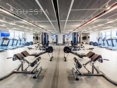 a gym with several treadmills and cardio machines at Emaar Beachfront - Beach Isle Tower 2, Dubai Marina in Dubai
