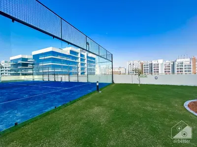 a tennis court on the roof of a building at Stunning studio with Balcony in Arjan in Dubai