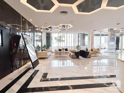 a lobby with couches and tables in a building at Stunning studio with Balcony in Arjan in Dubai