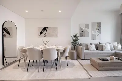 a living room with a table and a couch at Burj Khalifa View, High Floor, Dubai Mall Access, Gym, Infinity-Pool, Playground, BBQ, Family Friendly in Dubai