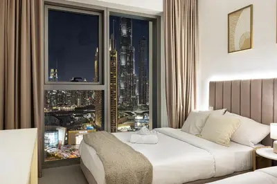 a hotel room with a bed and a large window at Burj Khalifa View, High Floor, Dubai Mall Access, Gym, Infinity-Pool, Playground, BBQ, Family Friendly in Dubai
