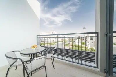 a balcony with a table and chairs and a view at Luxurious 3 BR with Maid Room in Arabian Ranches 2 in Dubai