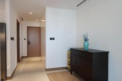 a hallway with a dresser with a vase on it at Livbnb - Modern 3BR with Marina & Sunset View in Dubai